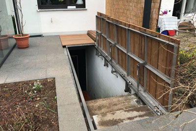 Cellar exit cover with gas springs