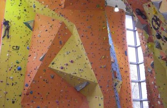 Climbing center with integrated door on rock wall
